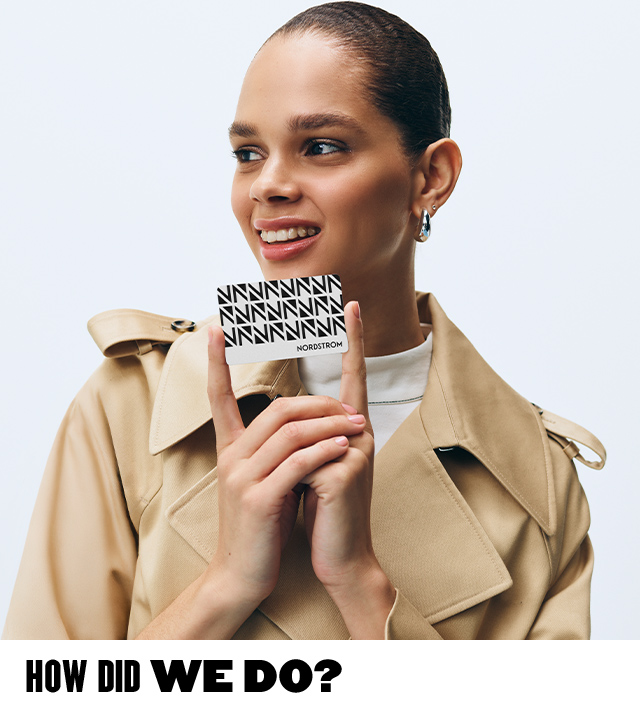 Woman holding a Nordstrom gift card.