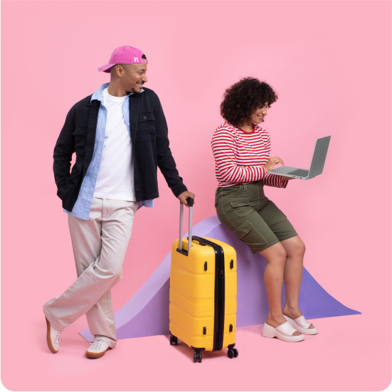 Man holding suitcase near a woman with a laptop