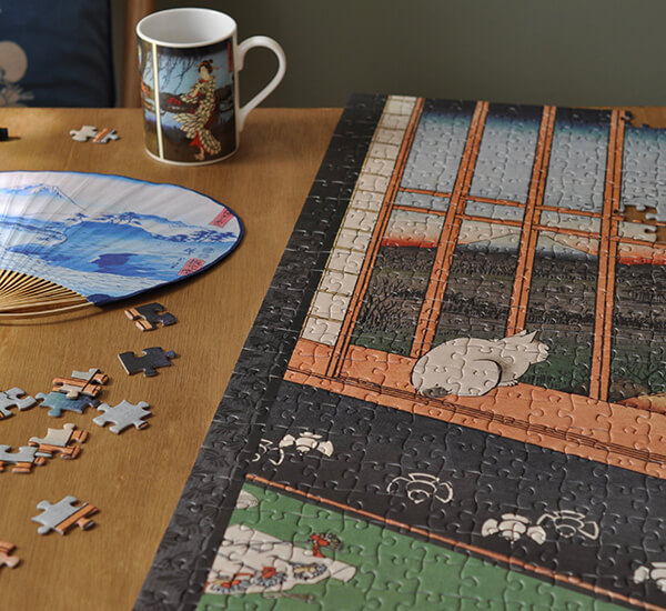 Hiroshige shop products, including a jigsaw, mug and fan.