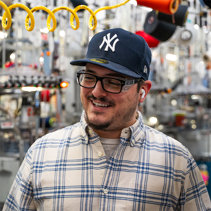 Travis M grins while working in the Mill