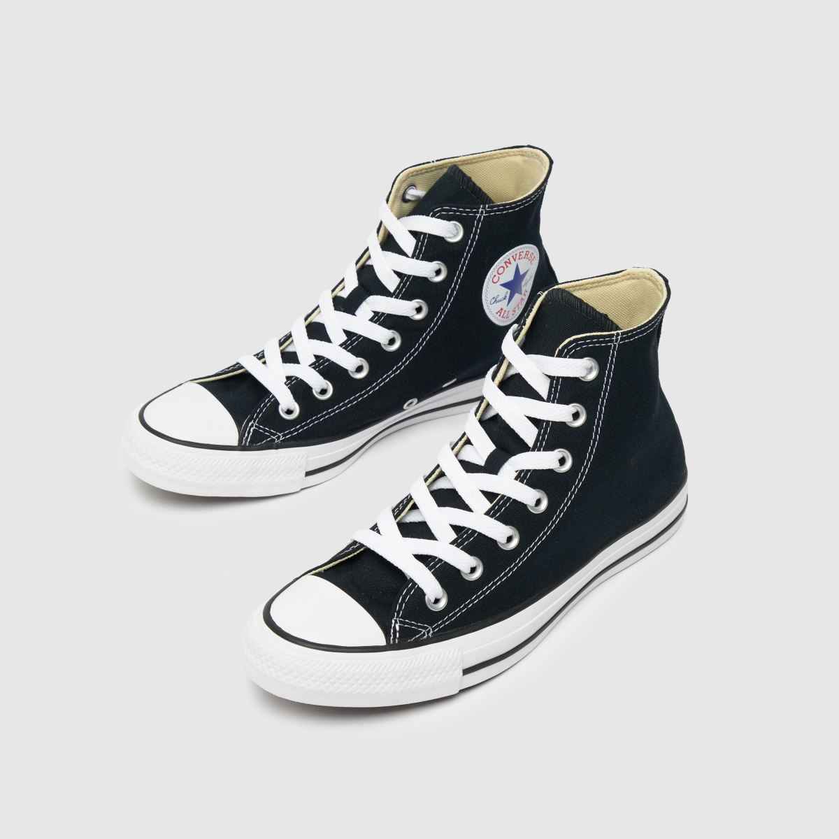 An image of a pair of black Converse trainers