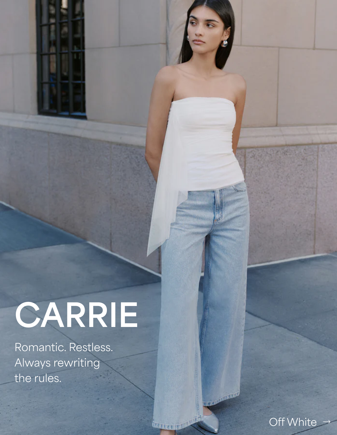 Sarah wears The Drea Top with a sheer side detail, described as “Romantic. Restless. Always rewriting the rules.”.