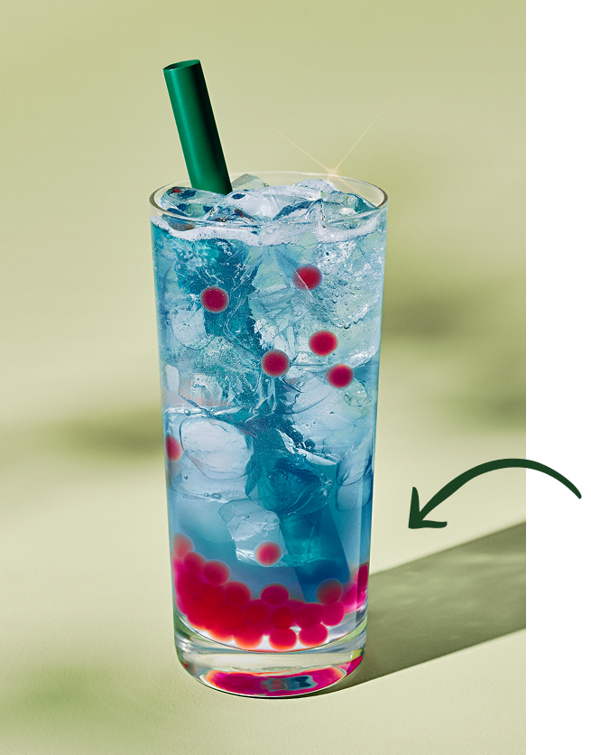 There is a photograph of a Starbucks Summer-Berry Refresher in a glass cup with a straw. The bottom of the drink has red, raspberry-flavored pearls.