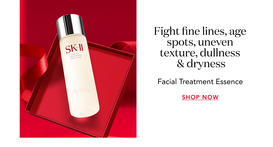 SK-II Facial Treatment Essence bottle displayed on red background with text “Fight fine lines, age spots, uneven texture, dullness & dryness” and “Shop Now.”