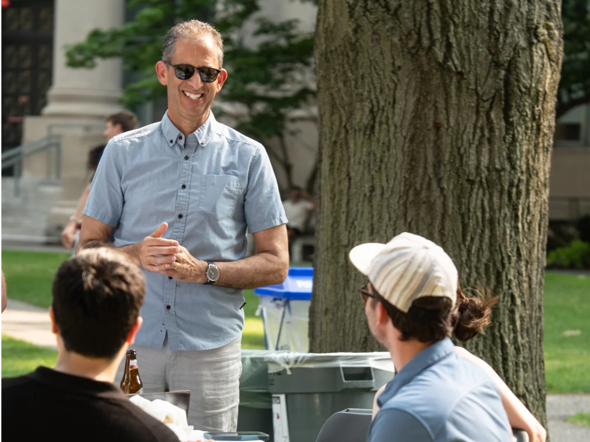 Dean Goldberg talking to table of people. 