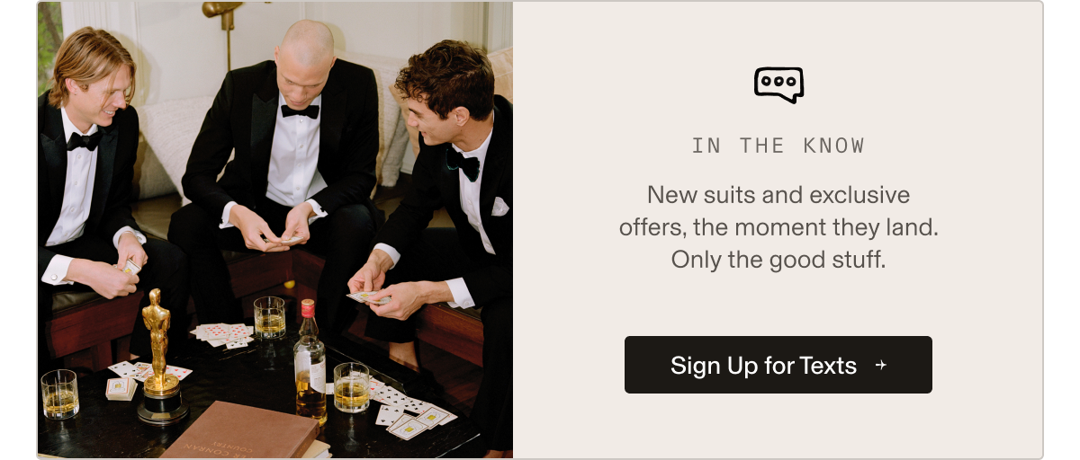 Three men in tuxedos sitting around a table playing cards with drinks and an Oscar-style trophy. Text on right side reads: "IN THE KNOW  New suits and exclusive offers, the moment they land. Only the good stuff.  Get Texts or Sign Up