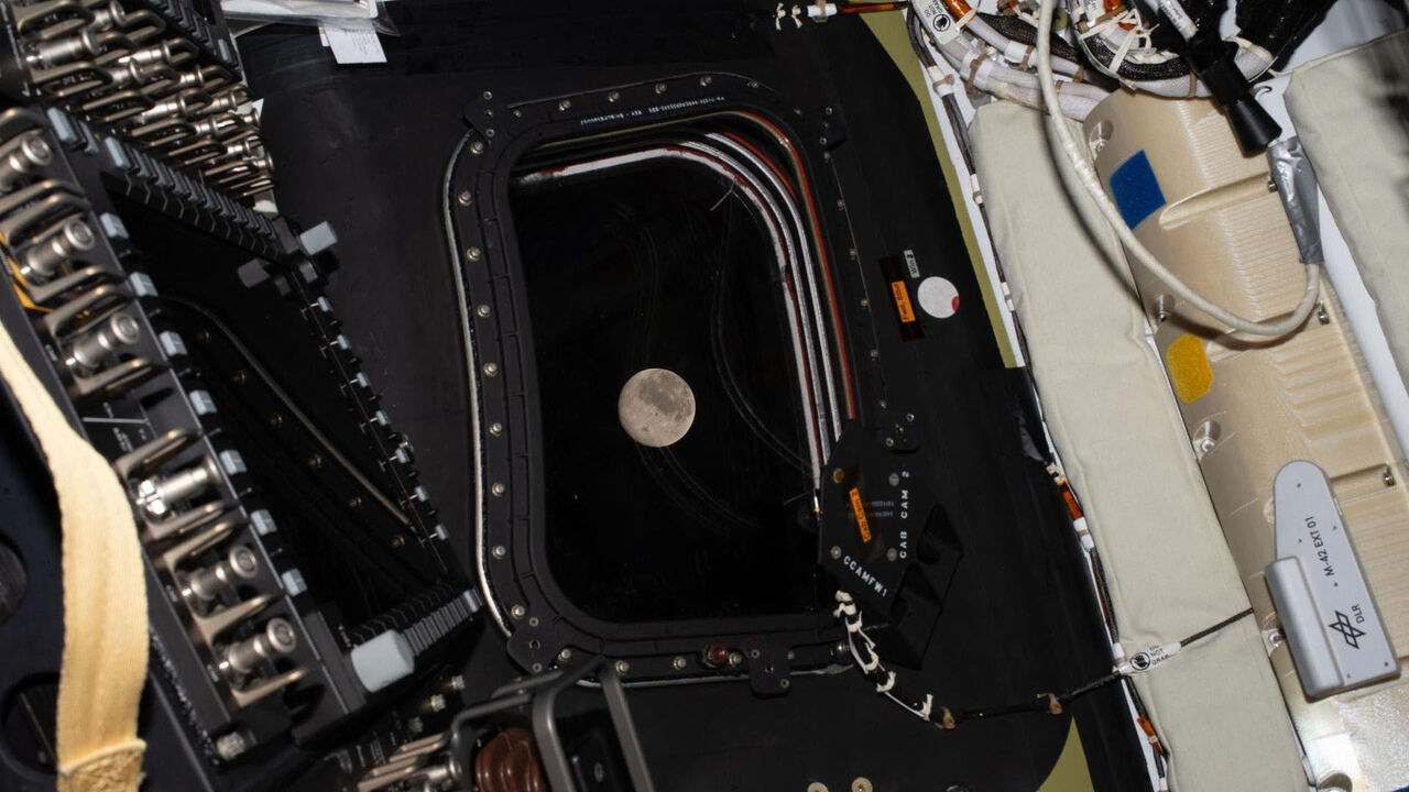 This handout picture by an Artemis II crew member provided by NASA shows the moon through a window of the Orion spacecraft.