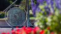 sundial with purple and red flowers