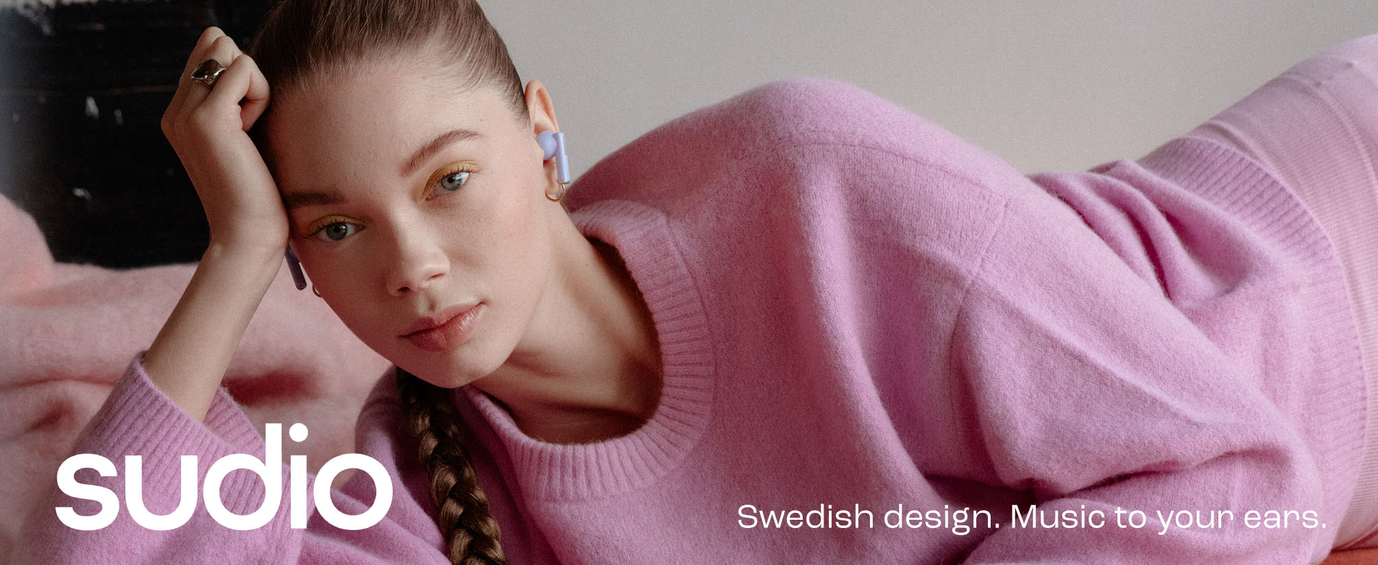 female model with sudio a1 pro earbuds
