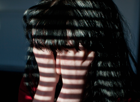 A woman with her face in her hands