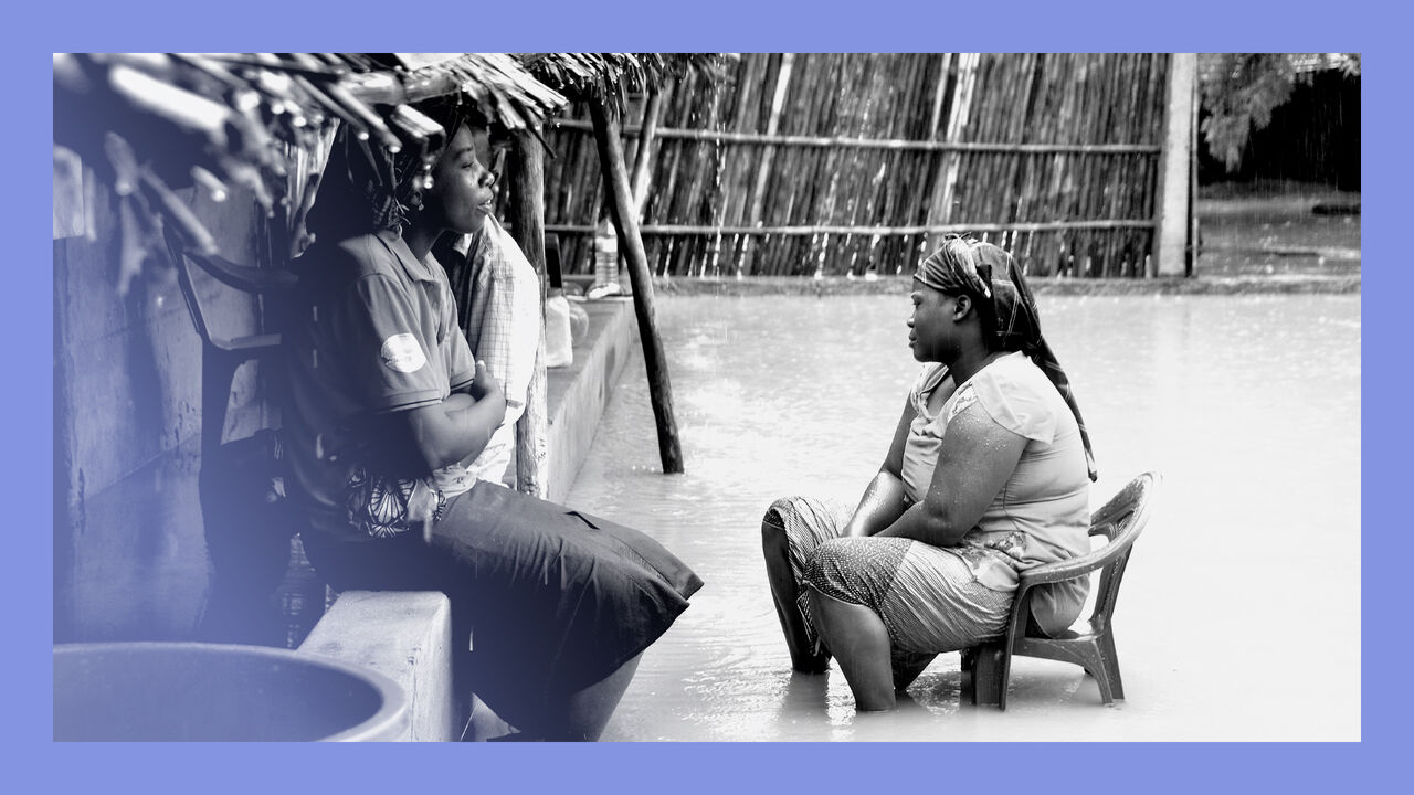 Neighbours chat while sitting in a flooded street of the Paquite district of Pemba, as Cyclone Kenneth hit northern Mozambique.