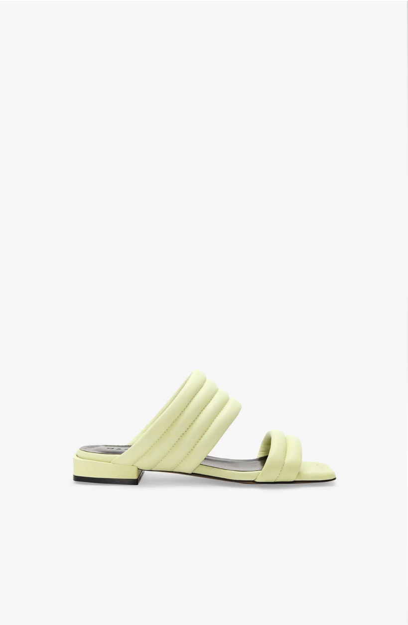 Side view of The Korin Sandals with a short square heel on a white background.