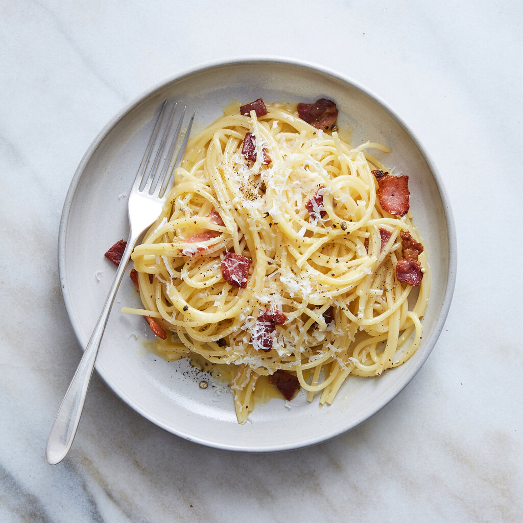 Spaghetti carbonara on a white plate.