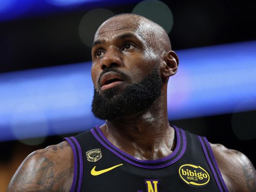 Figure wearing basketball jersey looks away dramatically