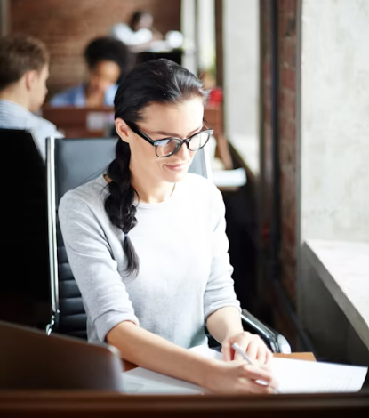 Student sitting at a desk, writing.