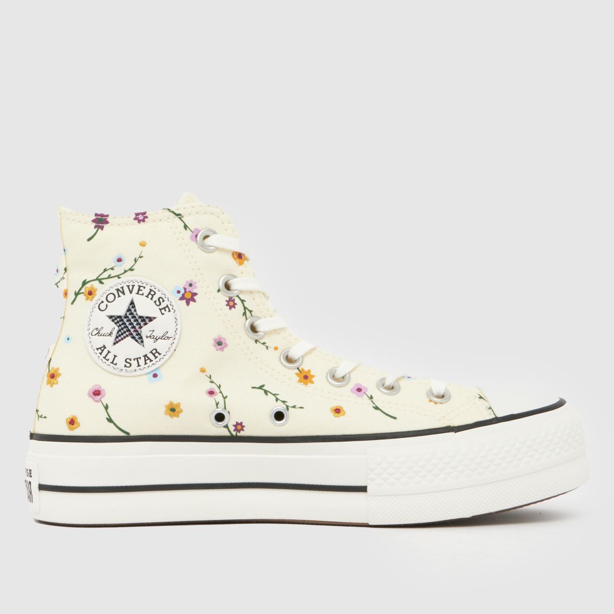An image of a beige Converse trainer with floral patterns