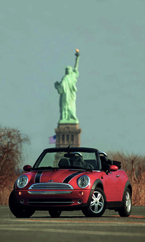 Red MINI in front of the Statue of Liberty