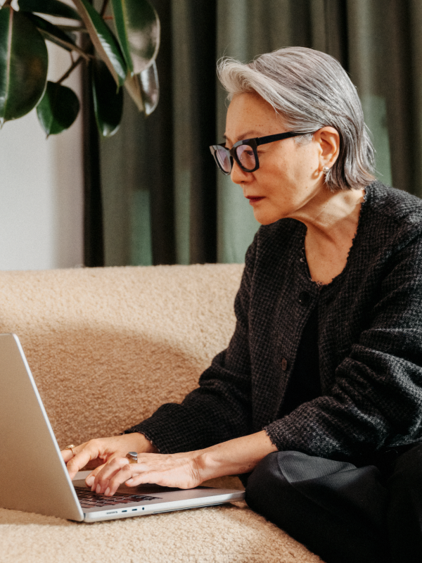 Photo-of-a-woman-working-on-a-laptop-smiling