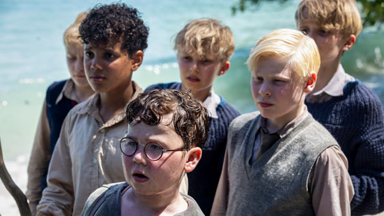 A group of boys look offscreen.