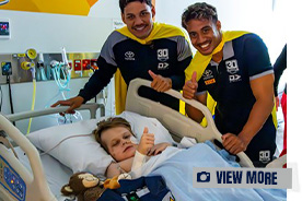 Cowboys in Capes visit Ronald McDonald House Family Room