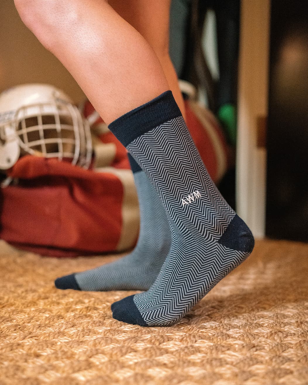man wearing stripped dress socks with AWM monogrammed on
