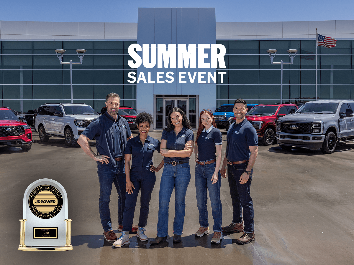 Members of the Ford Team stand together at a dealership beneath the words &ldquo;Summer Sales Event&rdquo; and next to a 2026 JD Power trophy for Highest Initial Quality Mass Market Brand.