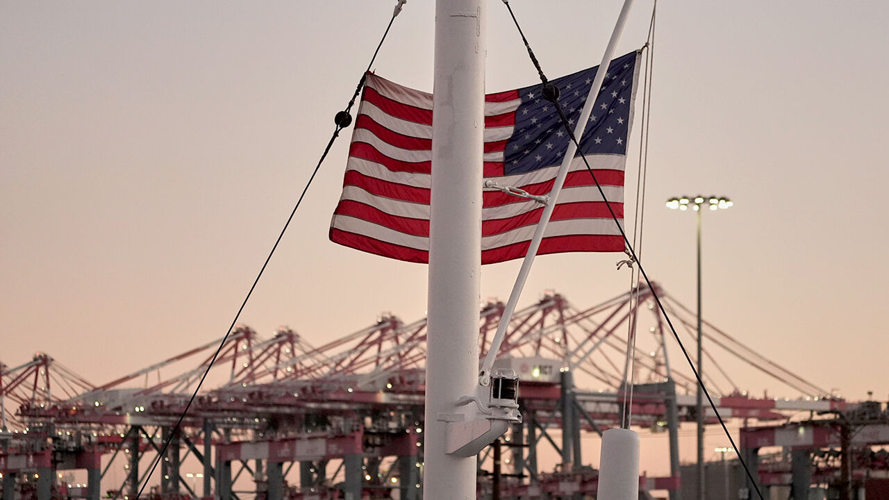 An American flag flies over The Long Beach Container terminal in California