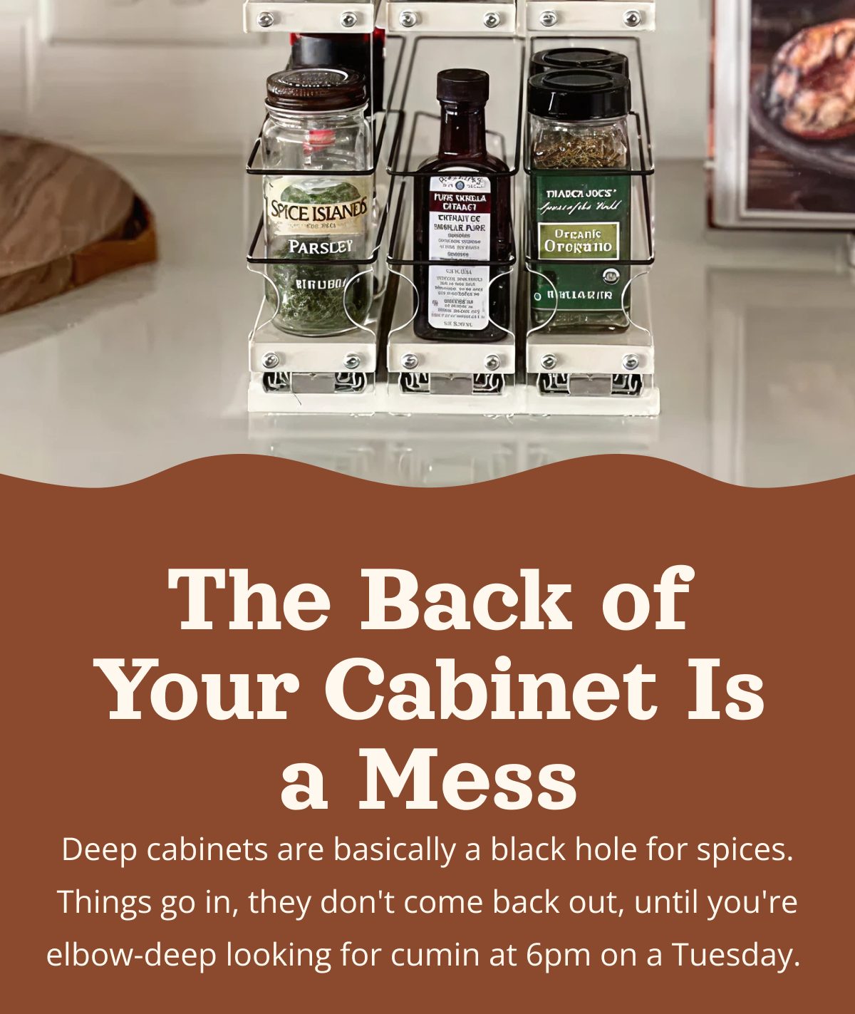 Slide-out spice rack drawer system inside deep kitchen cabinet showing neatly organized spice jars pulled forward for easy access