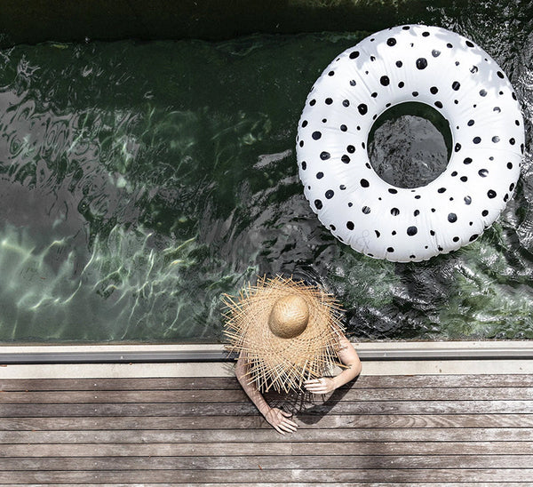 dotted pool floats with woman in sun hat