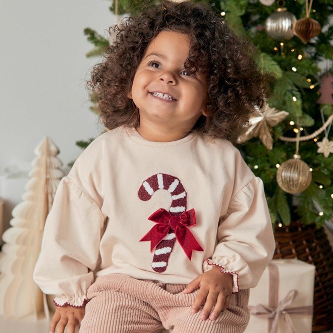 Toddler wearing candy cane christmas jumper