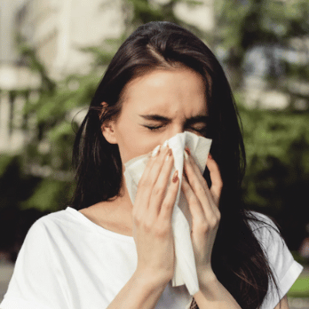 Woman sneezing