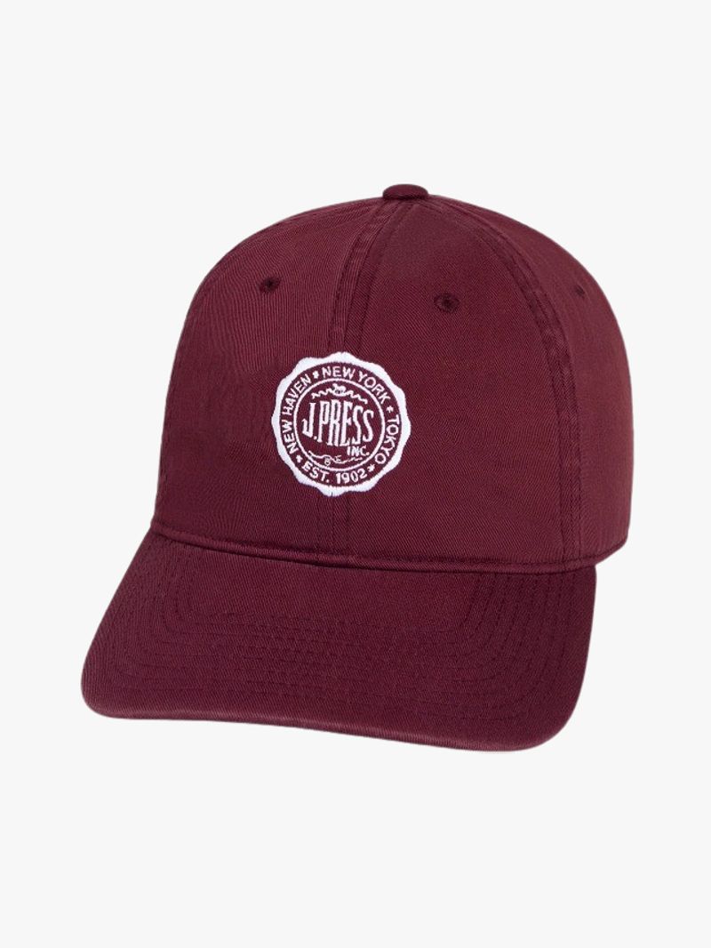 Image may contain: Baseball Cap, Cap, Clothing, Hat, and Maroon