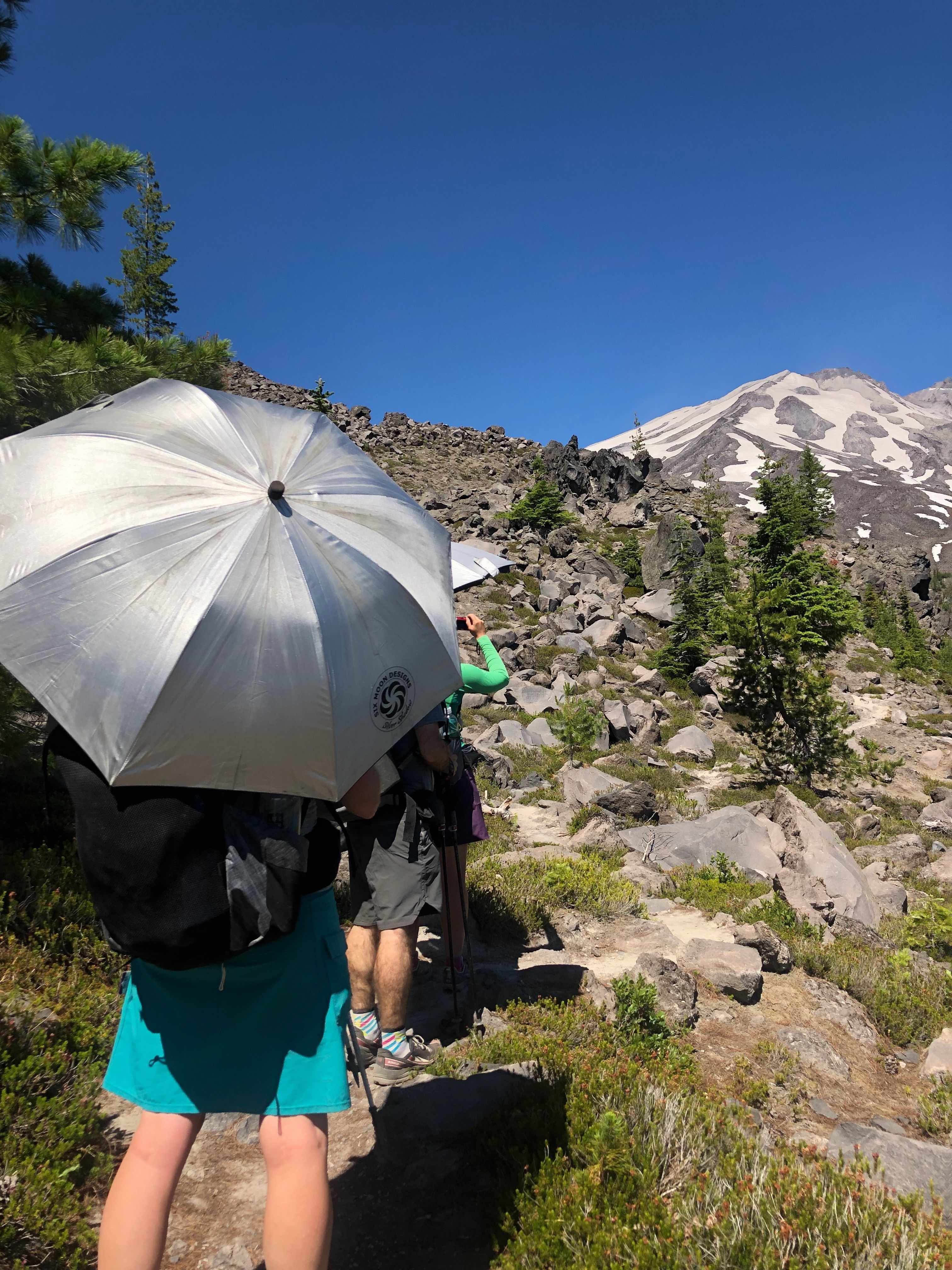 hiker with silver shadow carbon umbrella