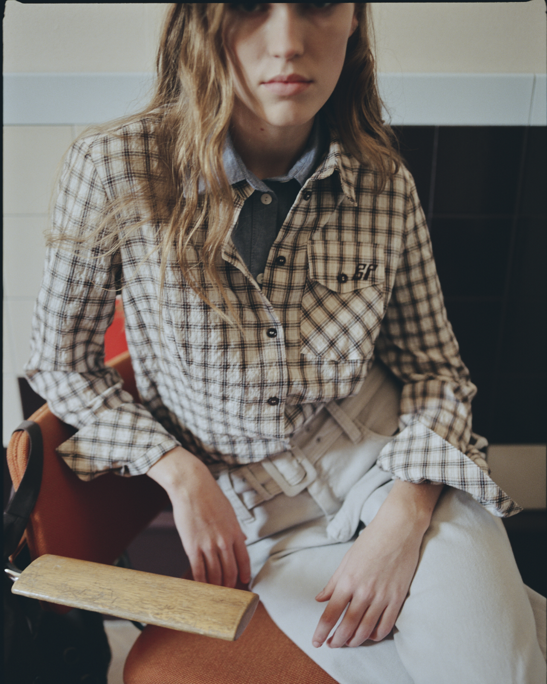 Girl in checked shirt and grey jeans
