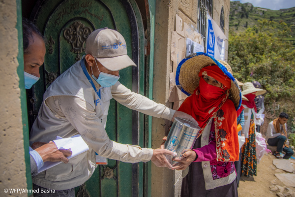 A woman receiving WFP food rations in Yemen.