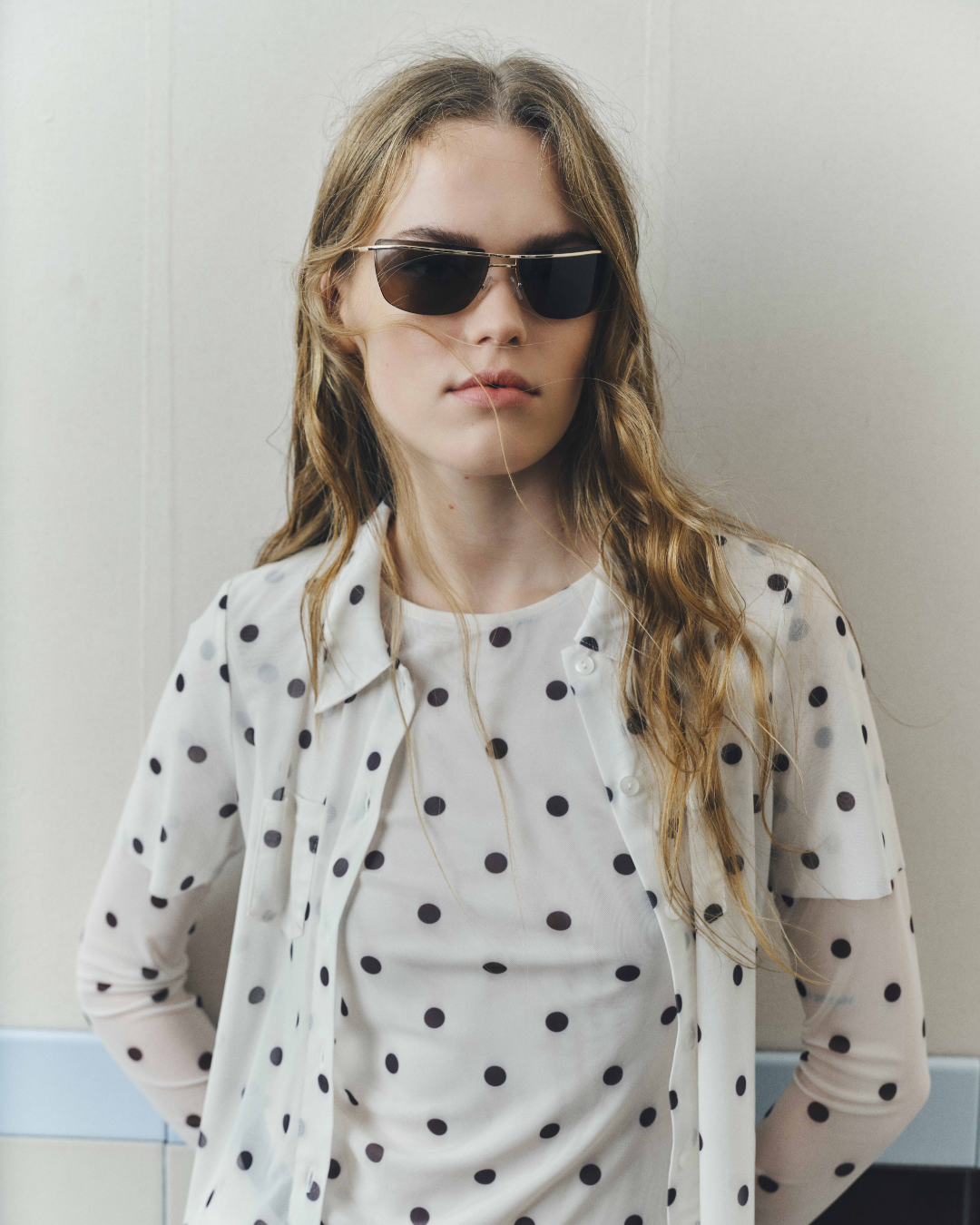 Girl with sunglasses and polka dots layered over polka dots
