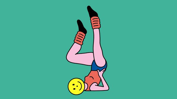A person with a yellow smiley face doing yoga