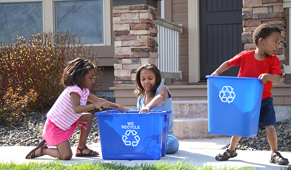 Kids carrying recycling bins