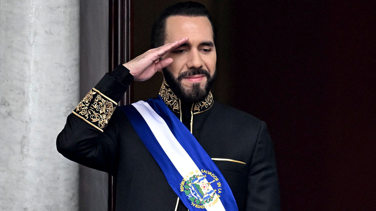 El Salvador's President Nayib Bukele salutes during a military parade 