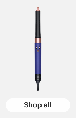 A Dyson Airwrap multi-styler on a gray tile.