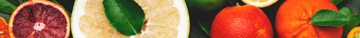 Various citric fruits in the background.