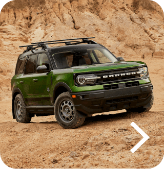 A Bronco&reg; Sport SUV Outer Banks&reg; model being driven off‑road in a desert landscape