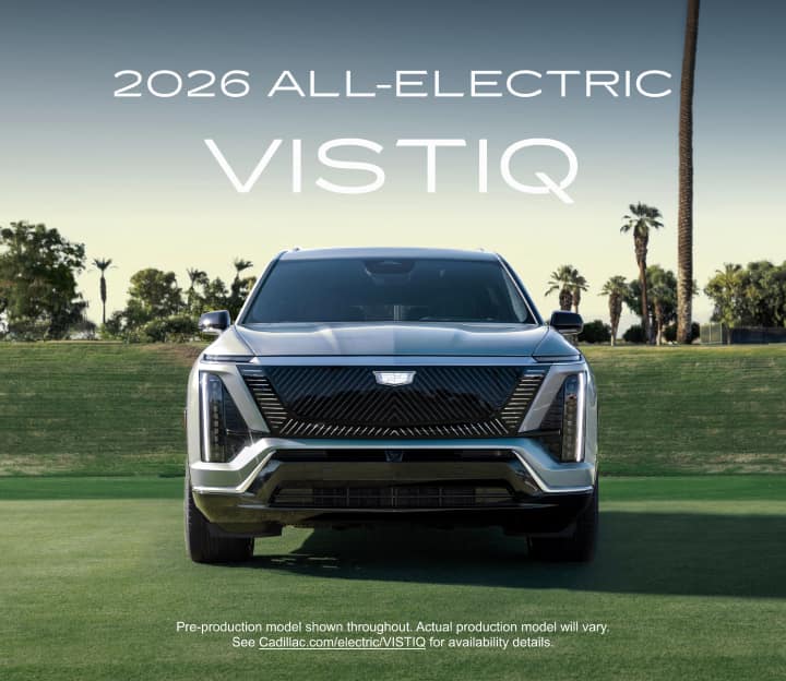 Front view of the 2026 VISTIQ mid-size electric SUV parked on a grassy tennis court with the title 2026 all-electric VISTIQ