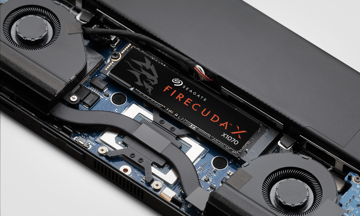 Close-up of a laptop's internal components featuring a Seagate FireCuda 510 SSD. 