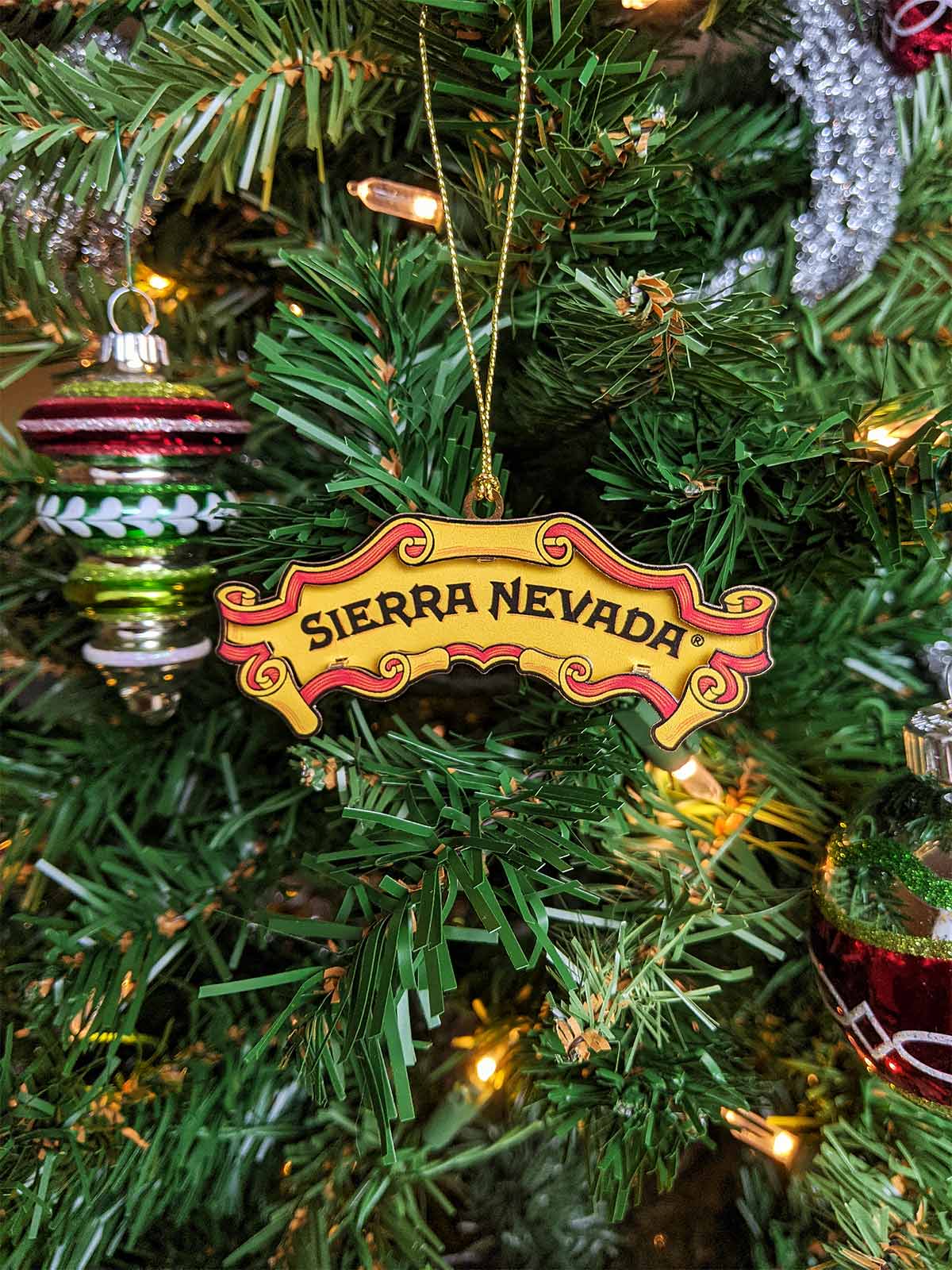 A Sierra Nevada logo ornament hanging on a tree
