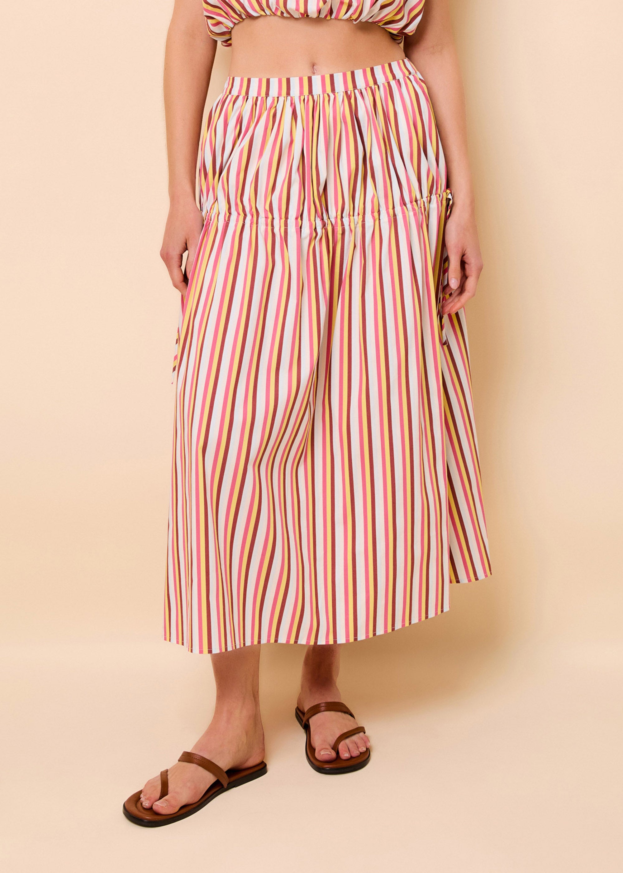 woman in a colorful stripped poplin full length skirt