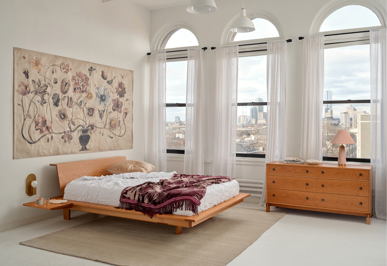 The Edo Platform Bed and Studio Horizontal Dresser in cherry in a city loft bedroom.