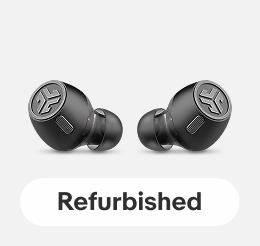 JBuds Air Wireless Earbuds on a light gray tile.