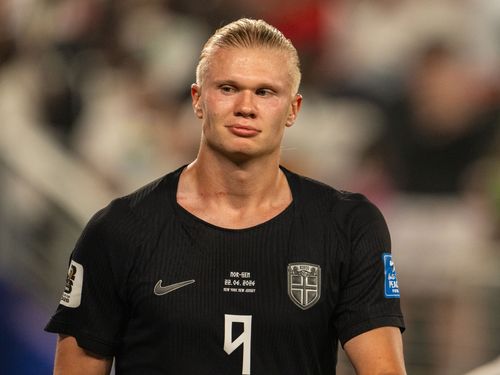 Erling Haaland in black soccer uniform.