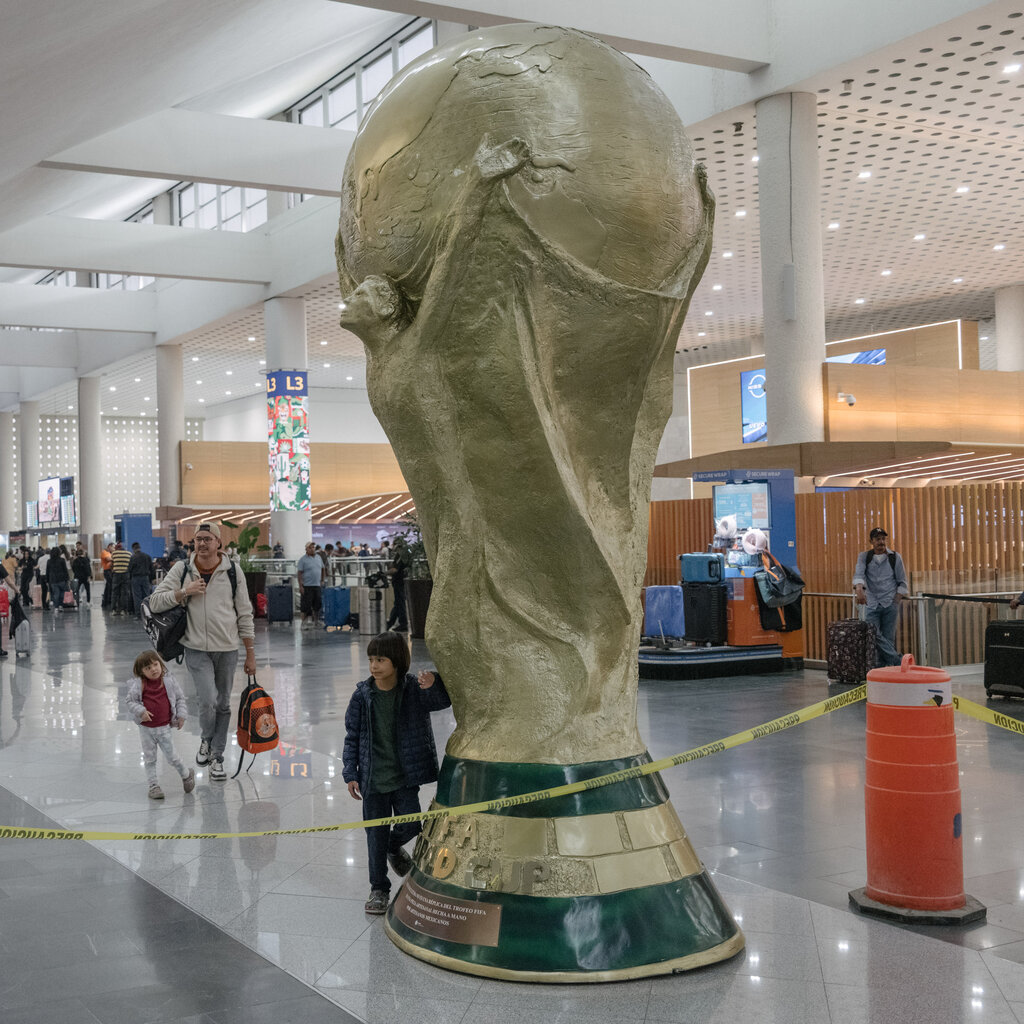 A replica of the World Cup trophy in an airport terminal. 